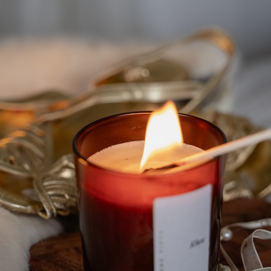 A Goddess candle being lit with a match